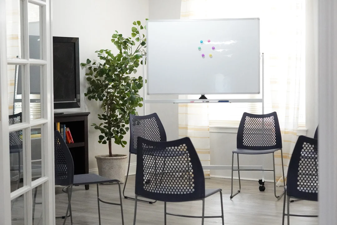 Circle of chairs and whiteboard for sessions