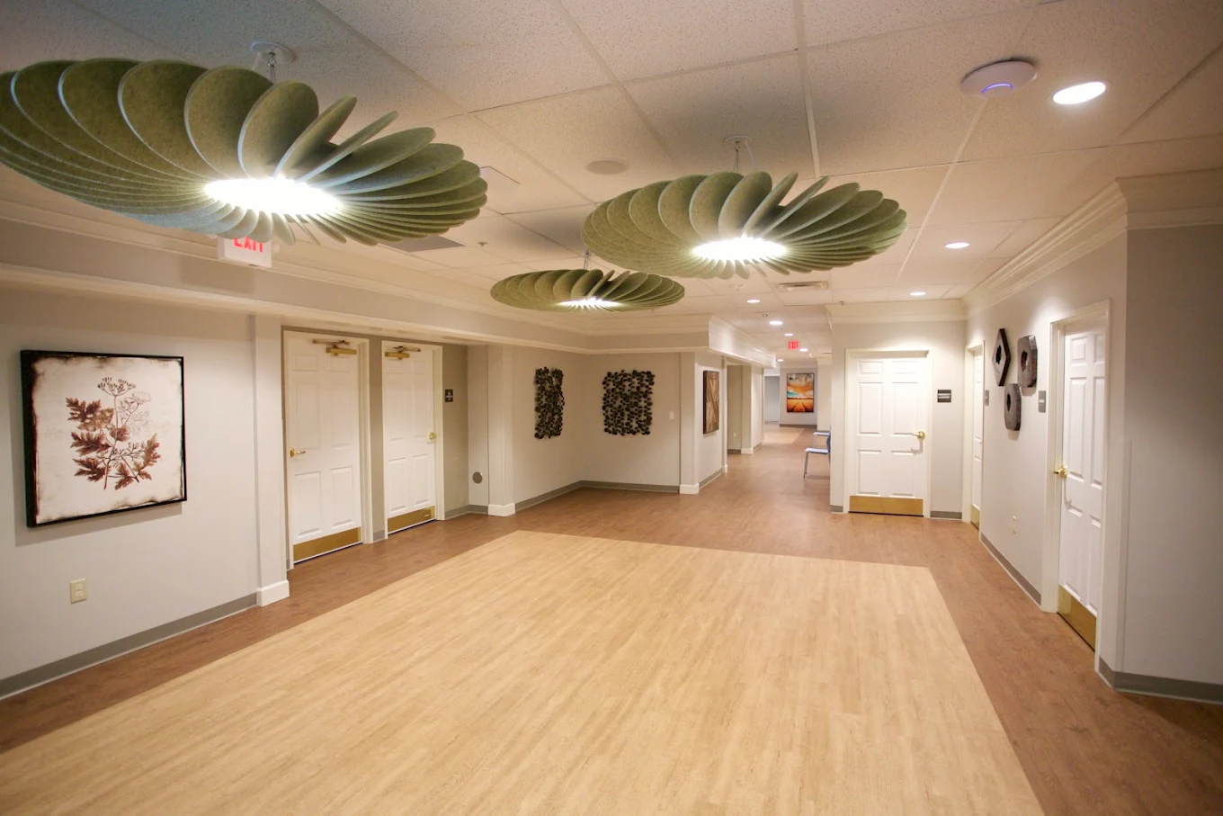 Spacious hallway with modern lighting and treatment rooms