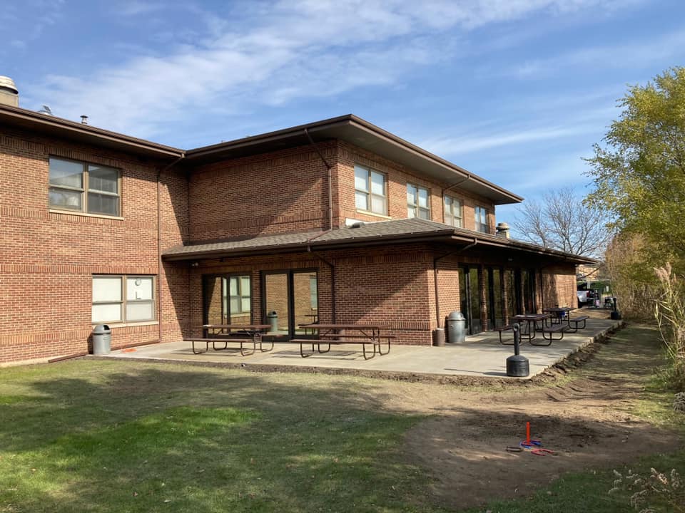 Outdoor patio with picnic tables behind the SHARE treatment building.