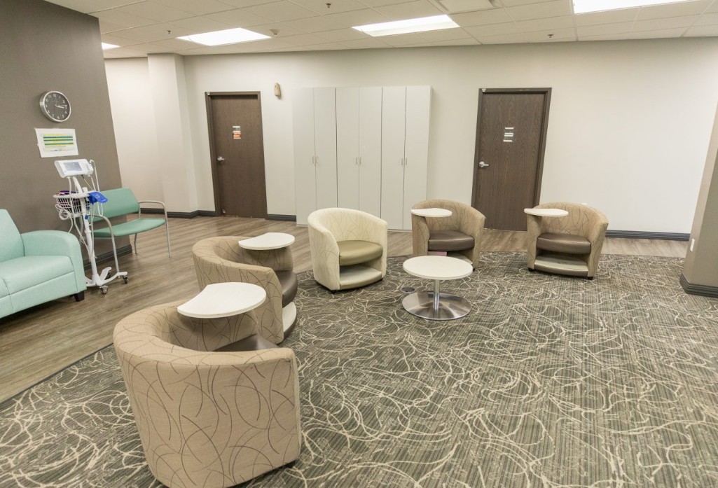 Lounge area with chairs, tables, and medical equipment
