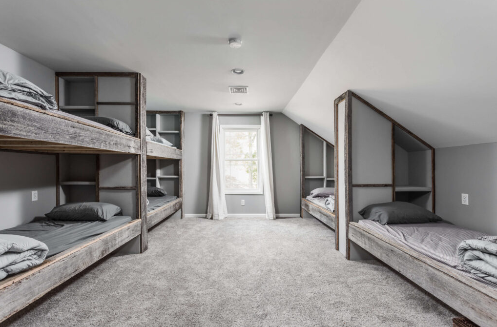 Shared bedroom with bunk beds and personal storage