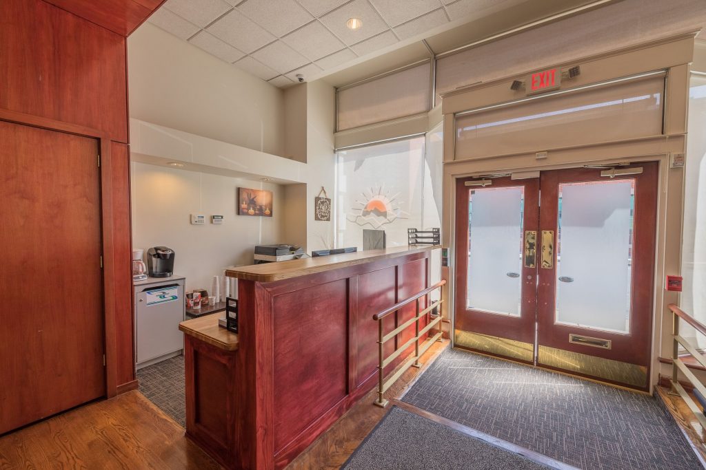 Reception desk and double glass doors with frosted panels