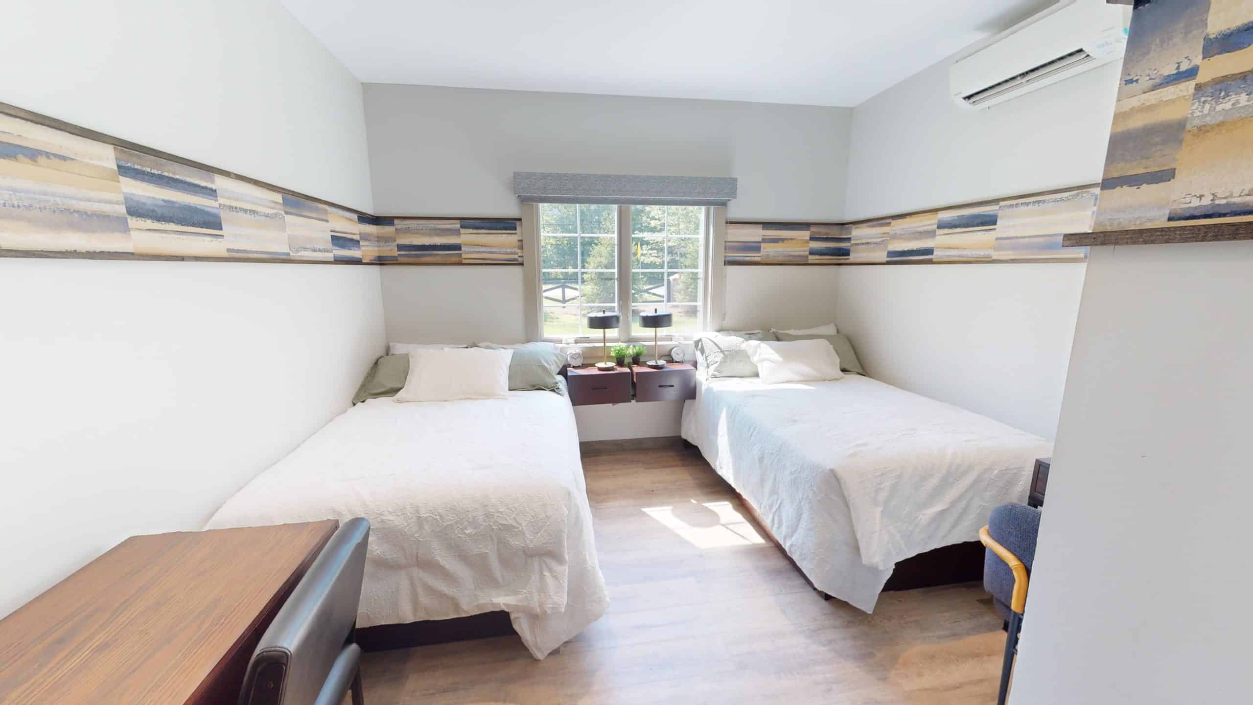 Bright shared room with twin beds and window view