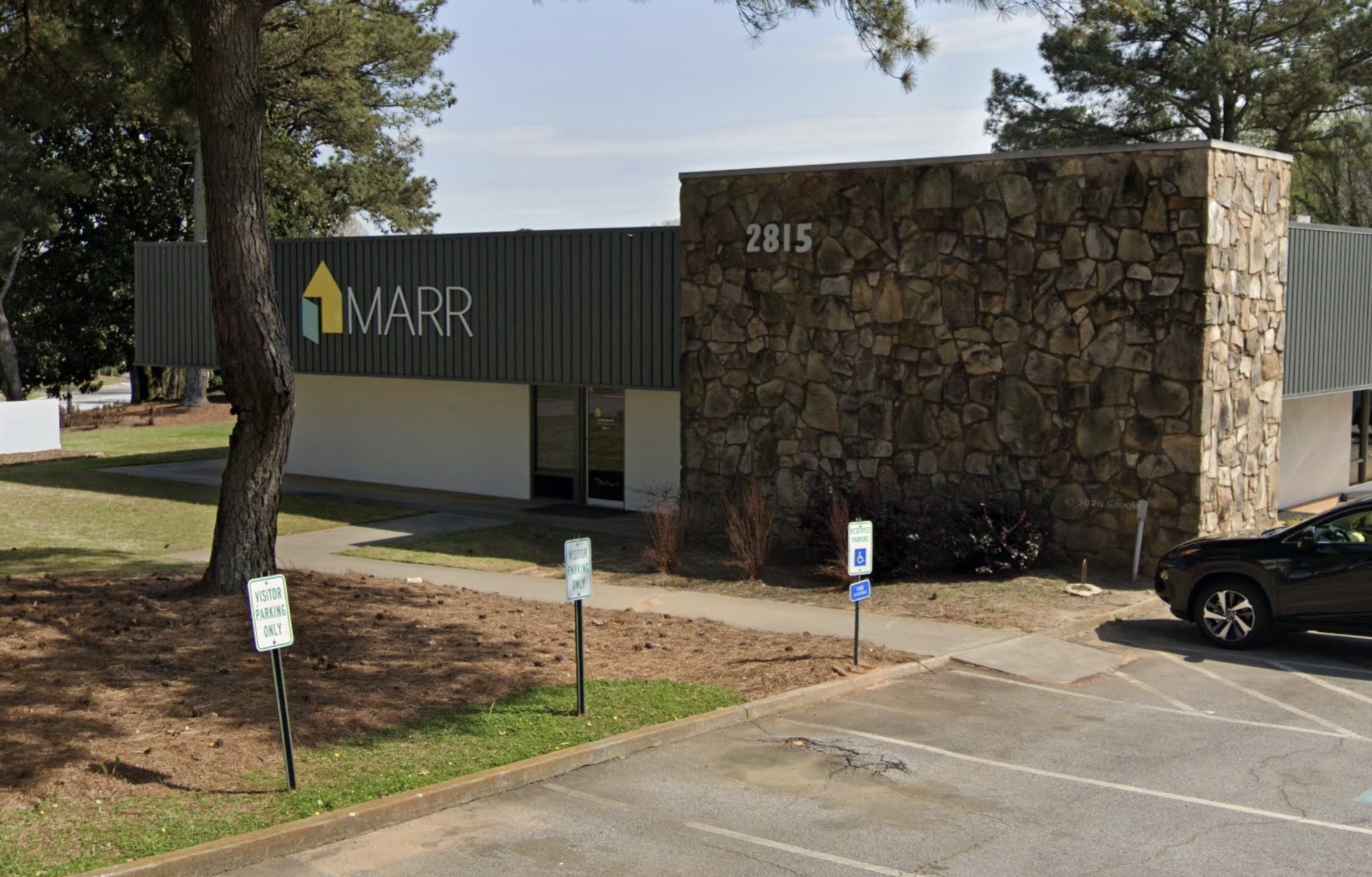 MARR facility exterior with stone facade and parking area