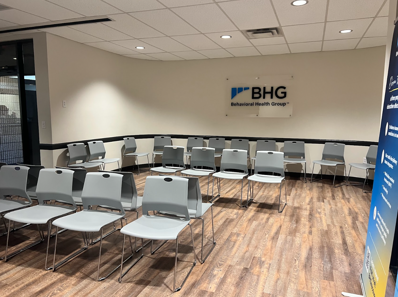 Spacious waiting room with rows of chairs for patients