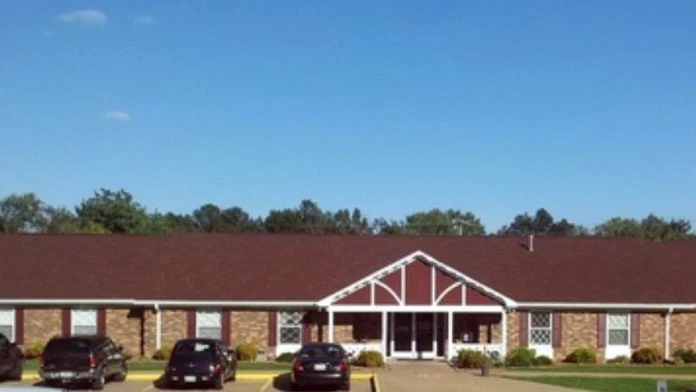 Single-story brick rehab facility with parking in front