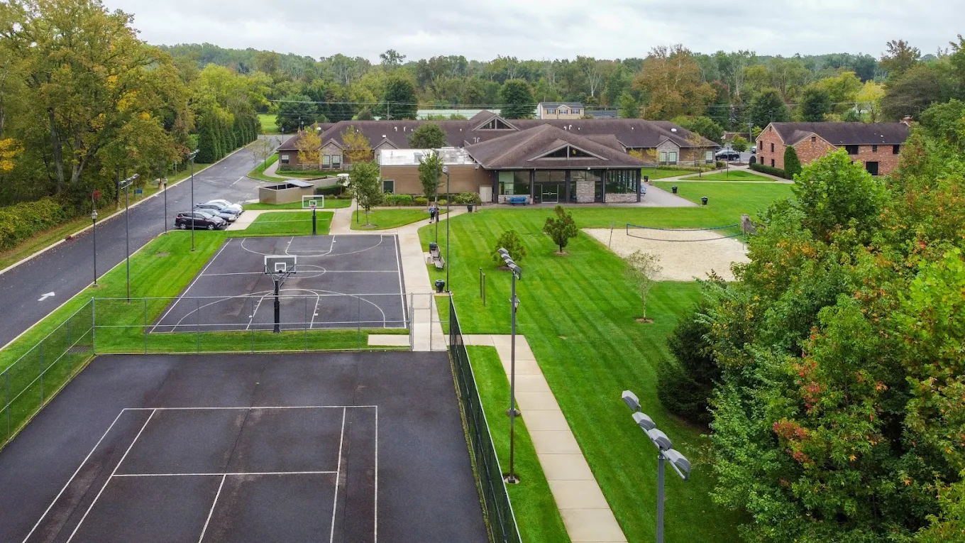 Aerial view of campus with buildings, courts, and green space