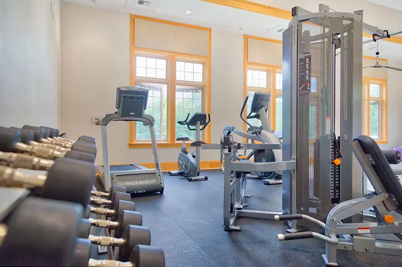 Gym with weights and exercise equipment.