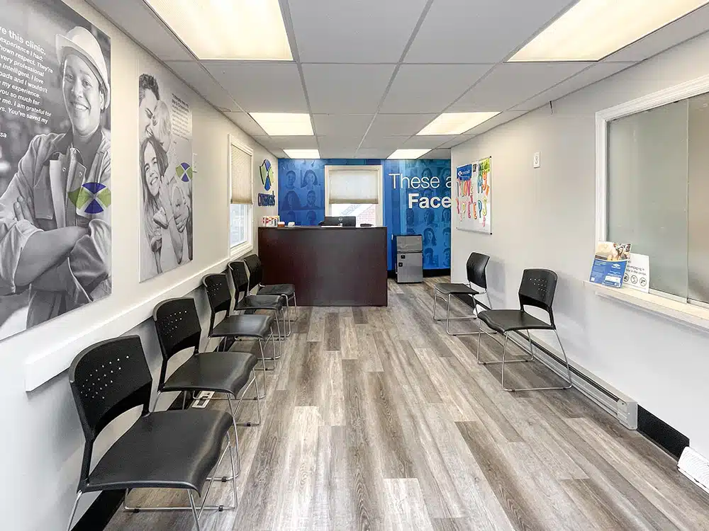 Narrow waiting room with chairs and front desk