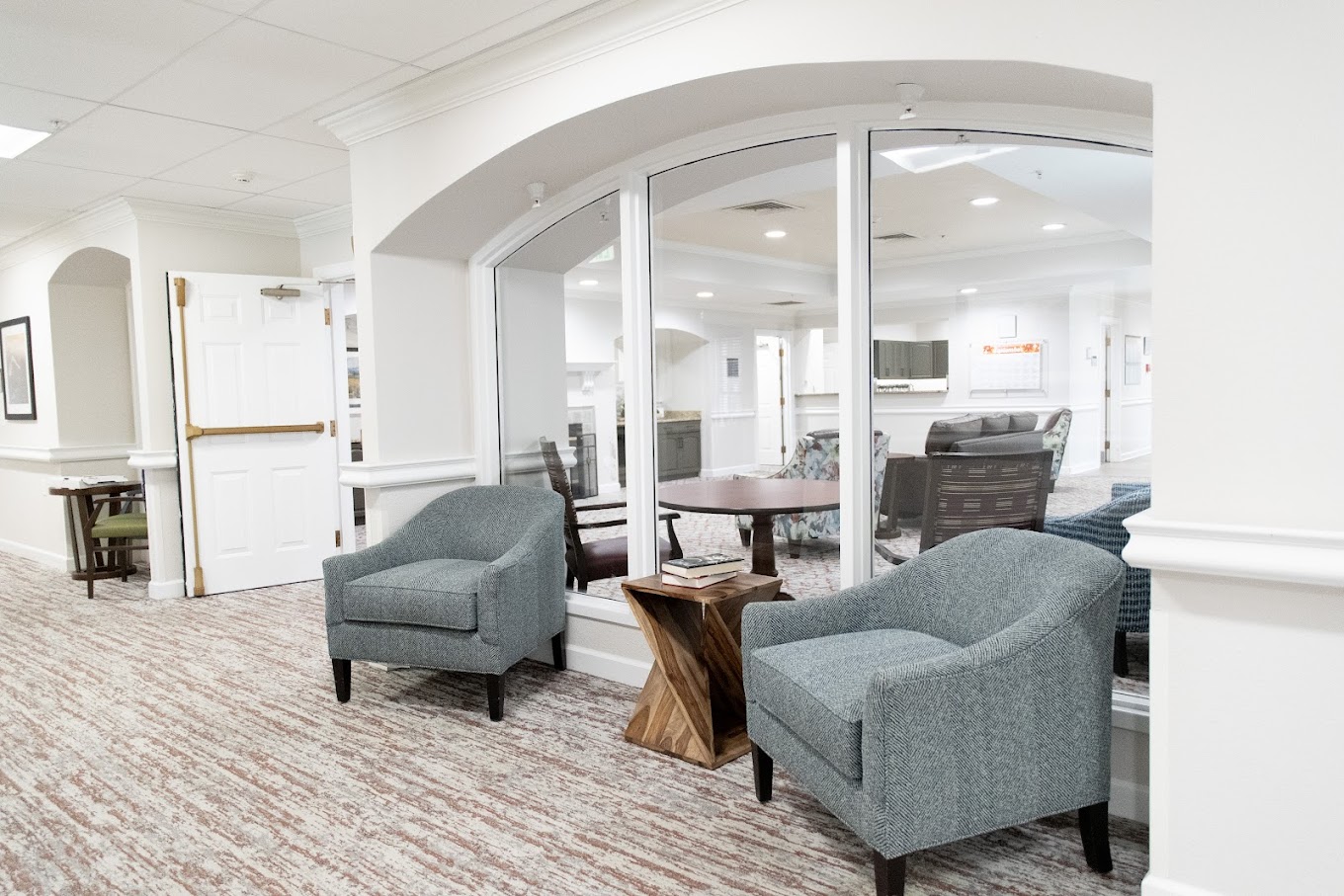 Quiet waiting area with armchairs and reading table
