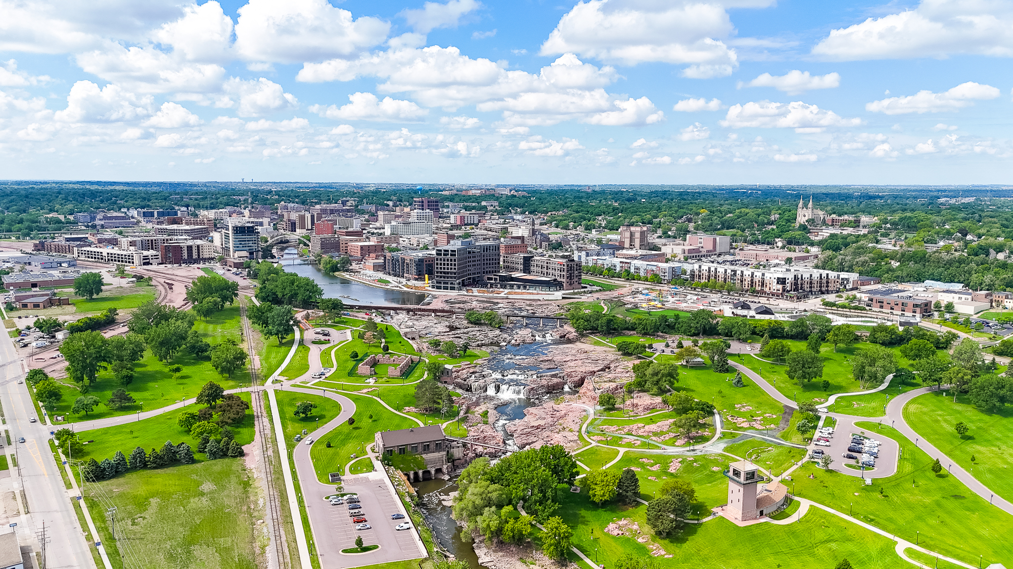 Aerial view of Sioux Falls with river and green parkland