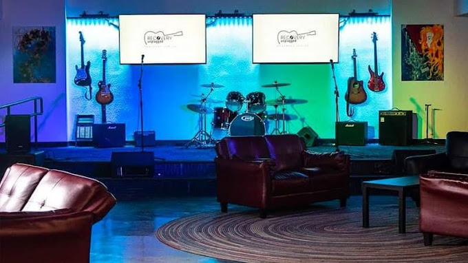 Live music stage with guitars, drums, and lighting