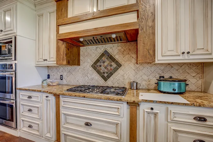Gourmet kitchen with custom cabinetry and stone countertops