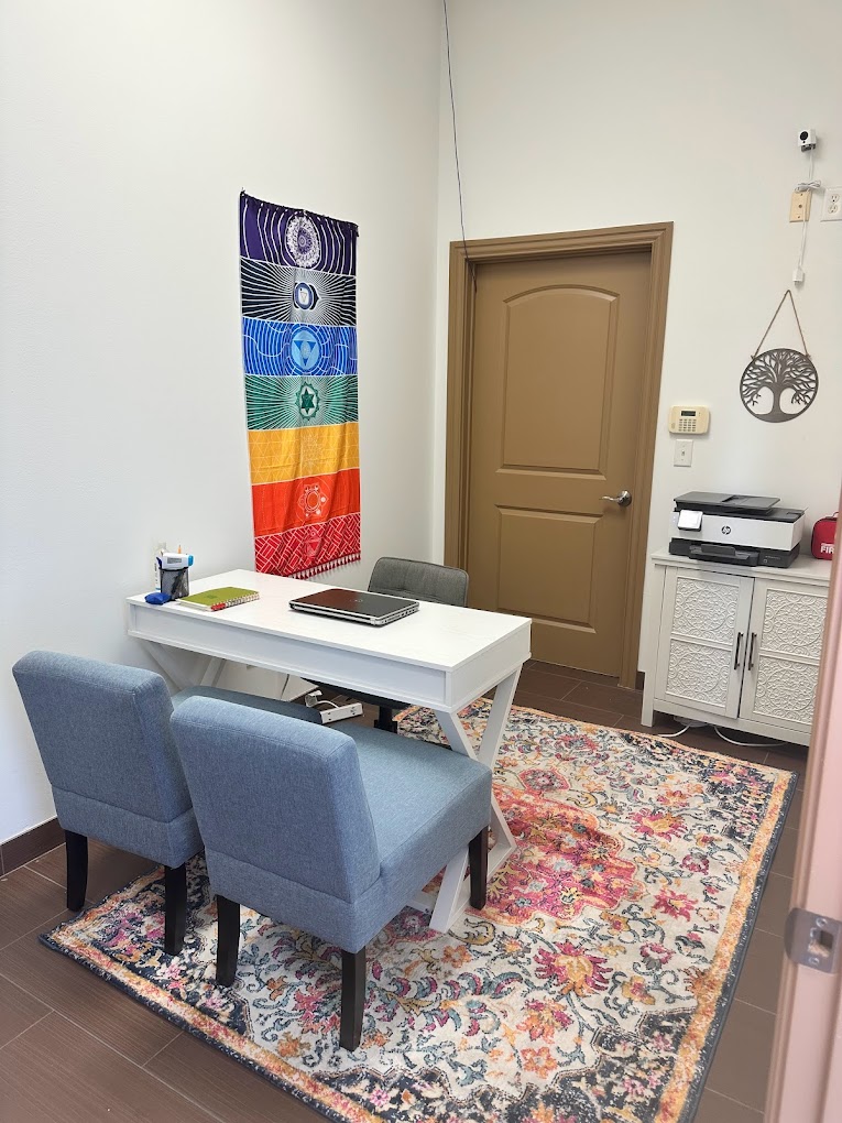 Cozy office space with a white desk and two chairs.