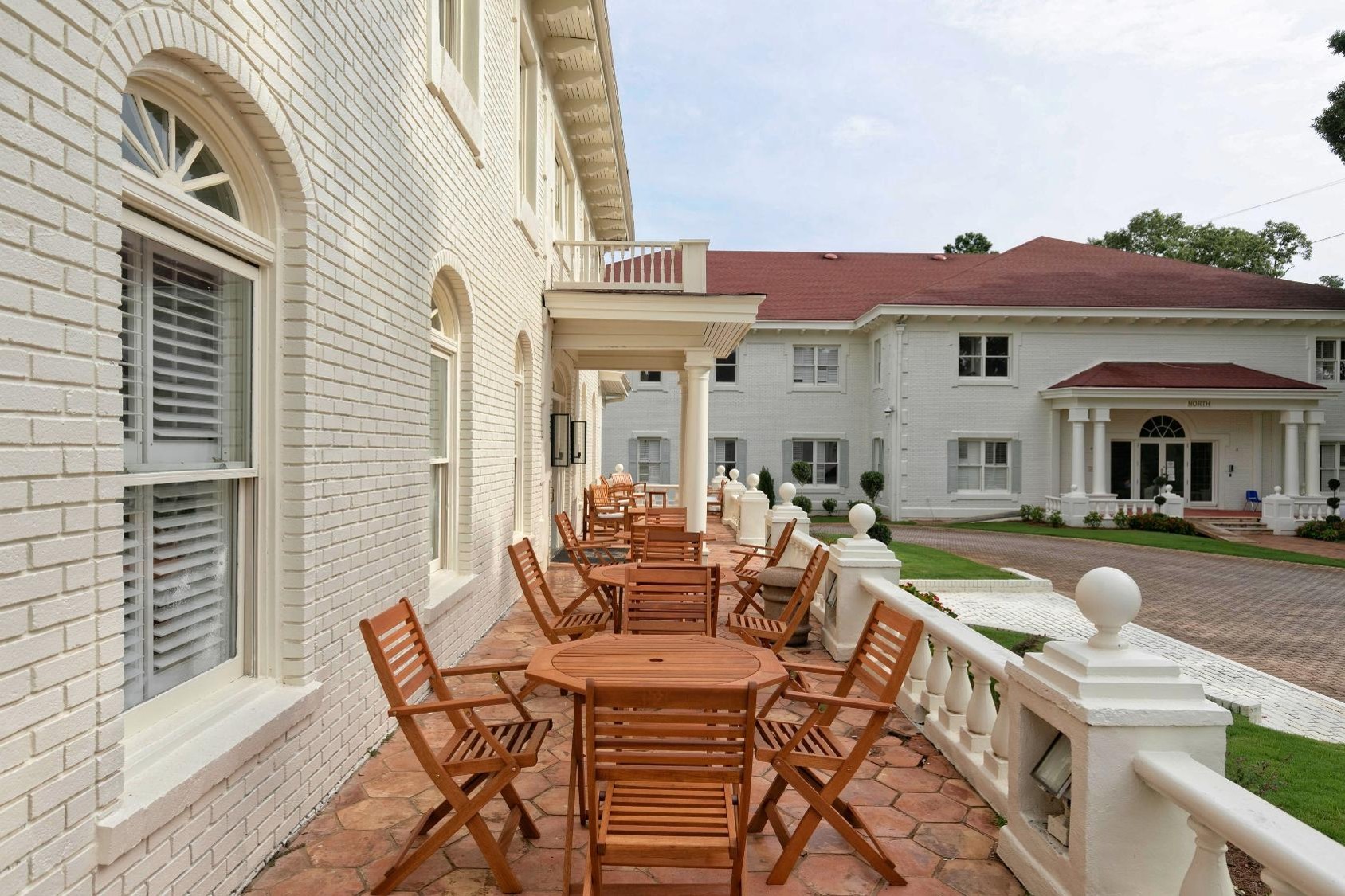 Brick patio with wooden tables and chairs