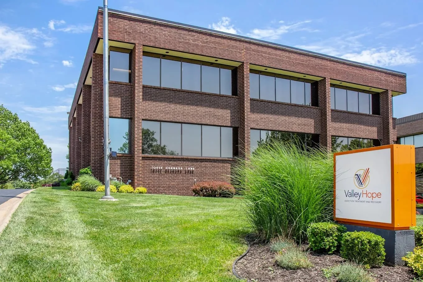 Brick facility exterior with Valley Hope sign and landscaping