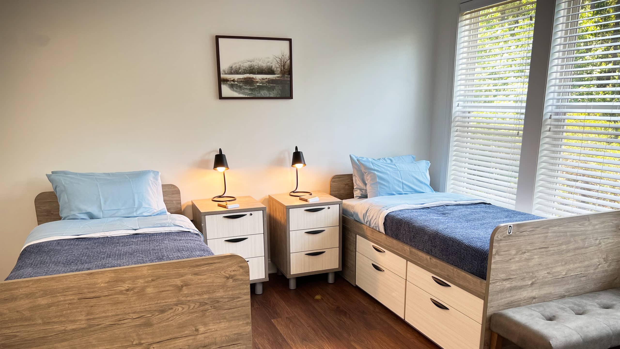 Shared bedroom with twin beds and soft lighting