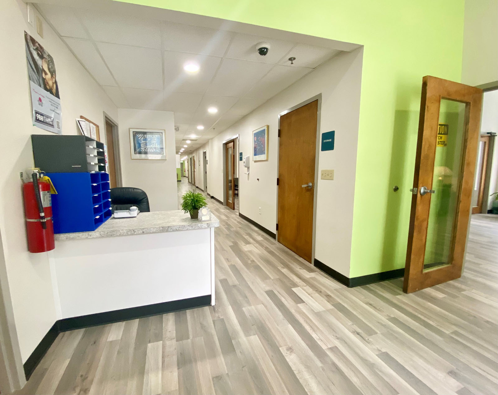 Treatment center hallway with reception desk and office doors