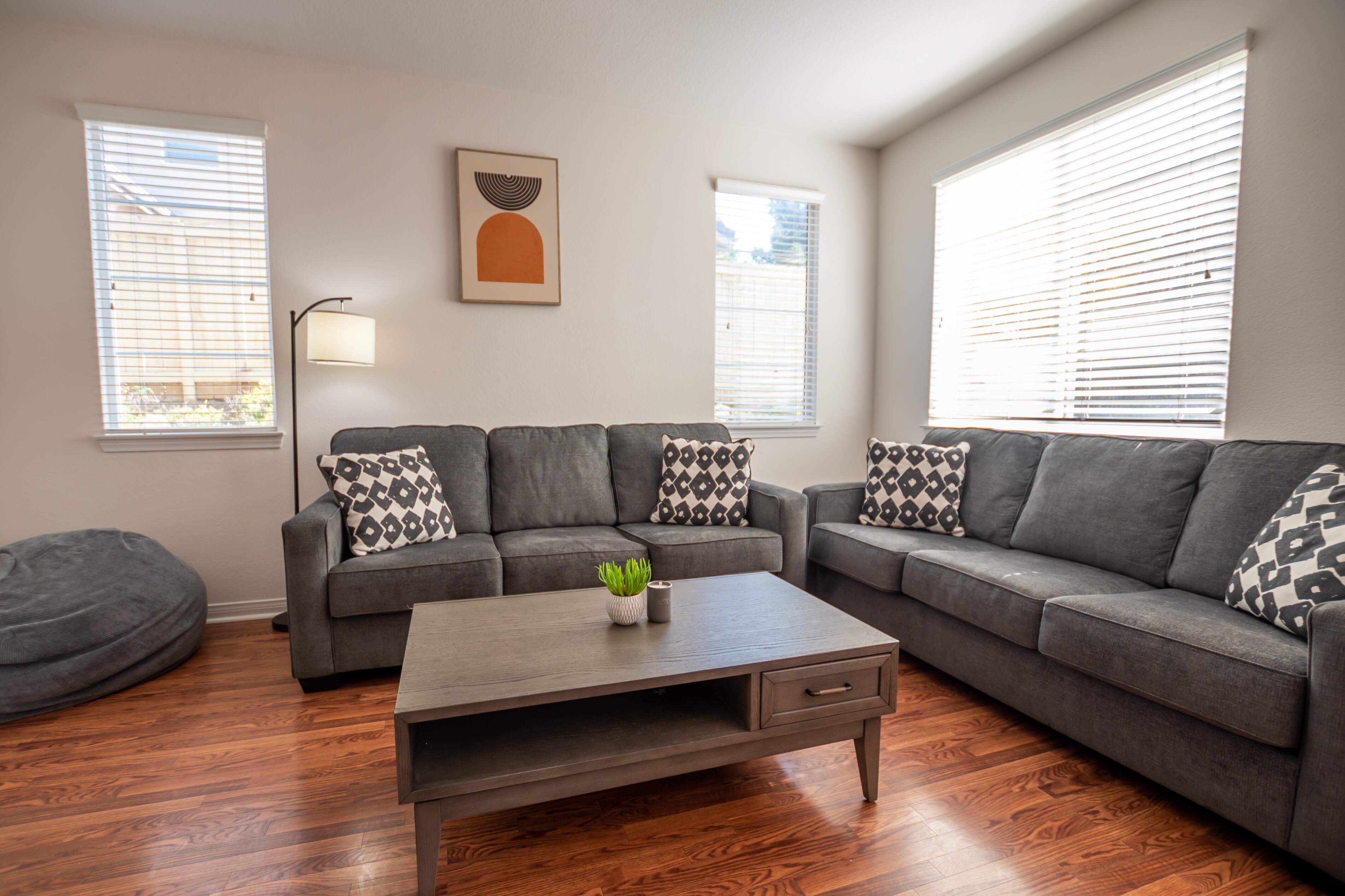 Cozy living room with grey couches and natural light