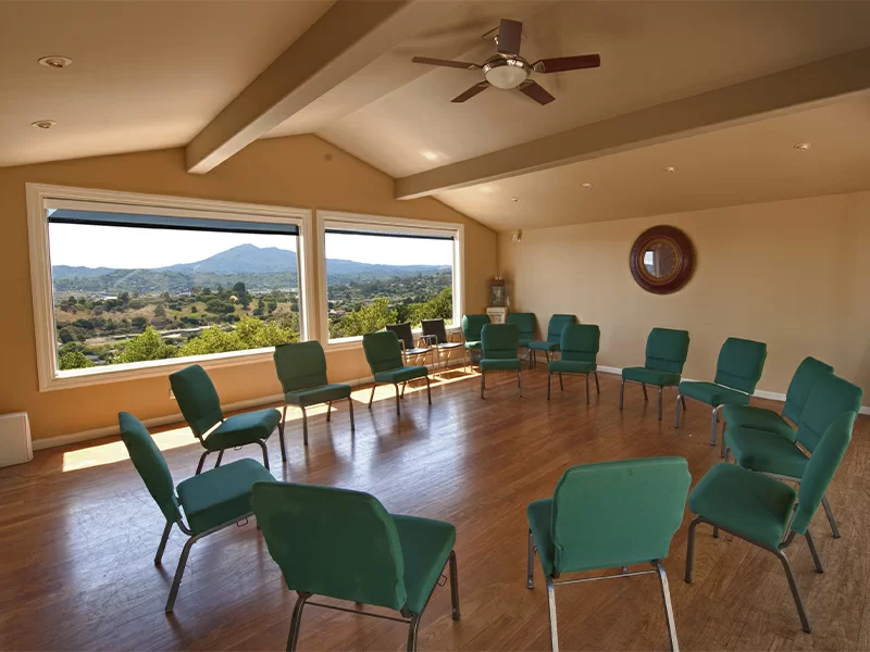 Spacious room with chairs arranged in a circle and large scenic windows
