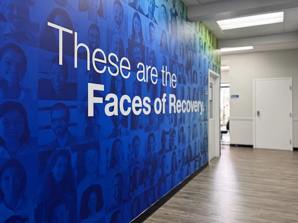 Hallway with large Faces of Recovery wall mural