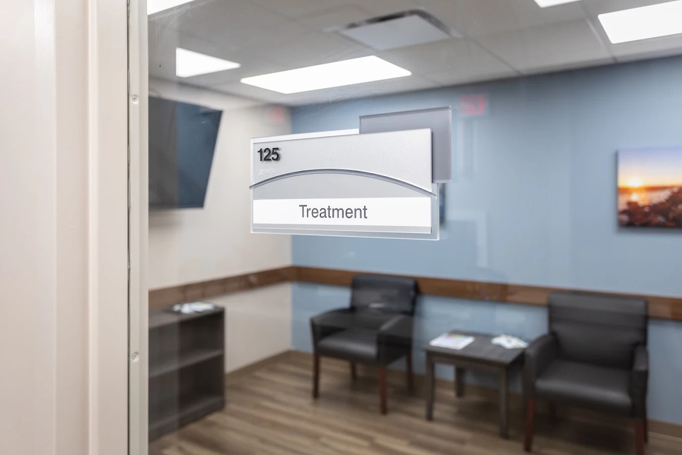 Treatment room entrance with room 125 sign and seating visible inside