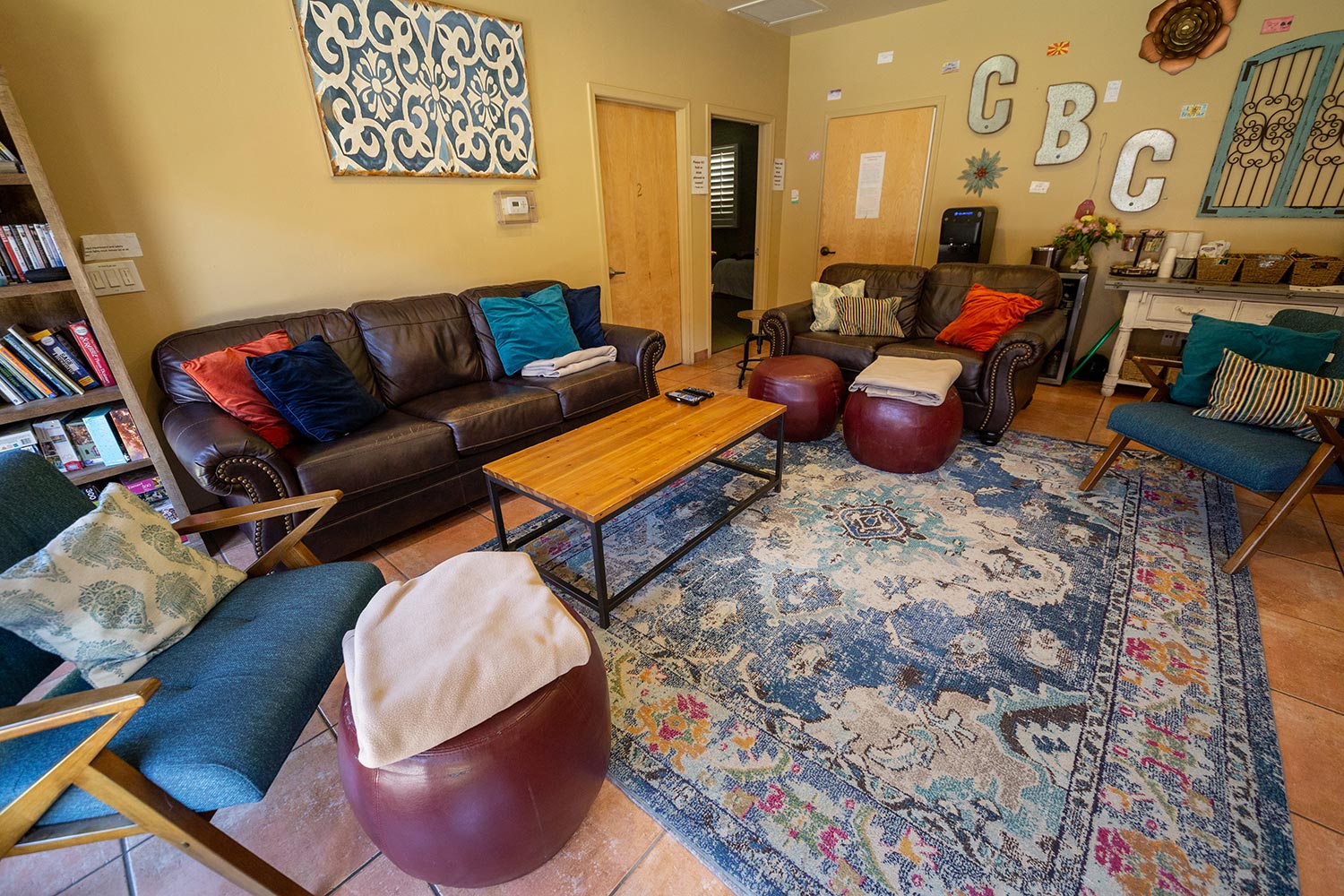 Cozy lounge with couches, chairs, and colorful decor
