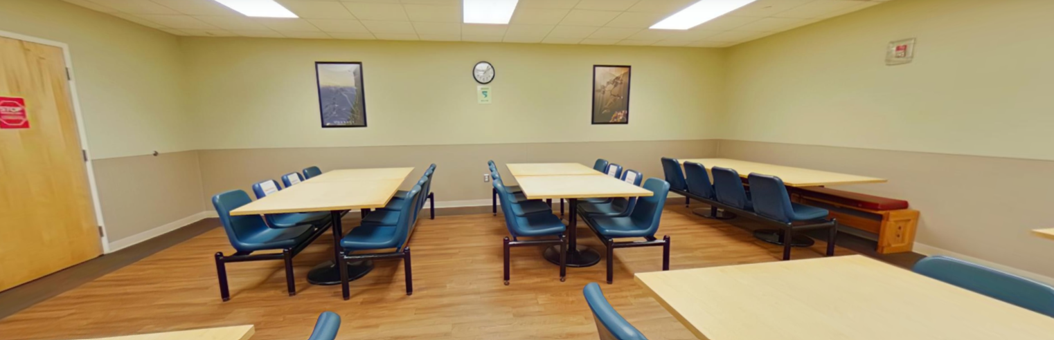 Dining room with shared tables and blue chairs
