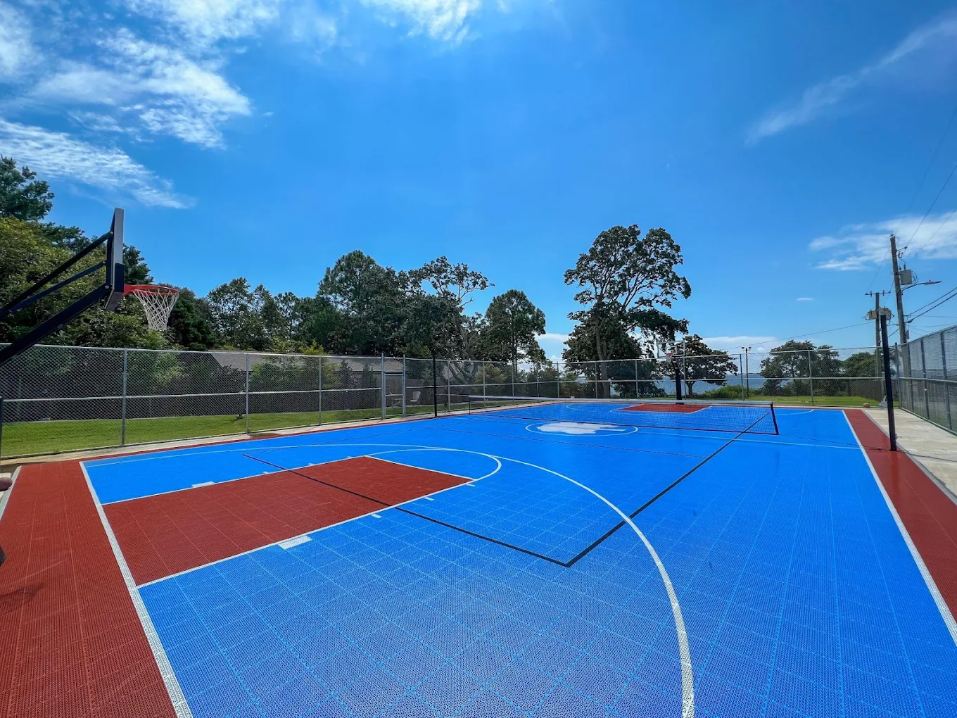 Bright blue and red basketball court with clear sky