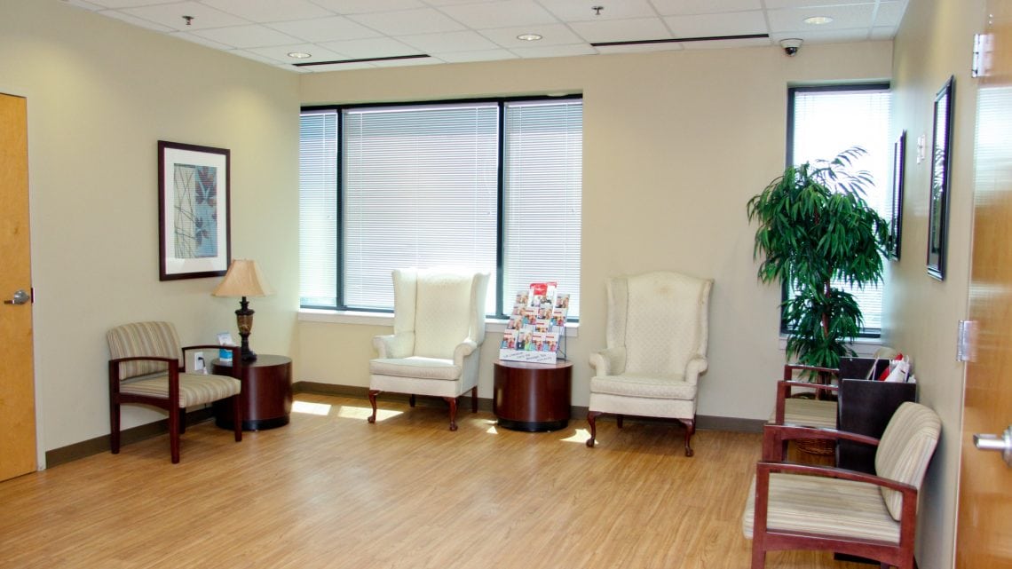 Bright reception area with seating and large windows