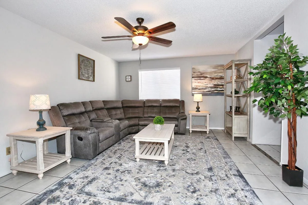Bright communal lounge with sectional seating at Sanctuary Sober Living Rose Garden