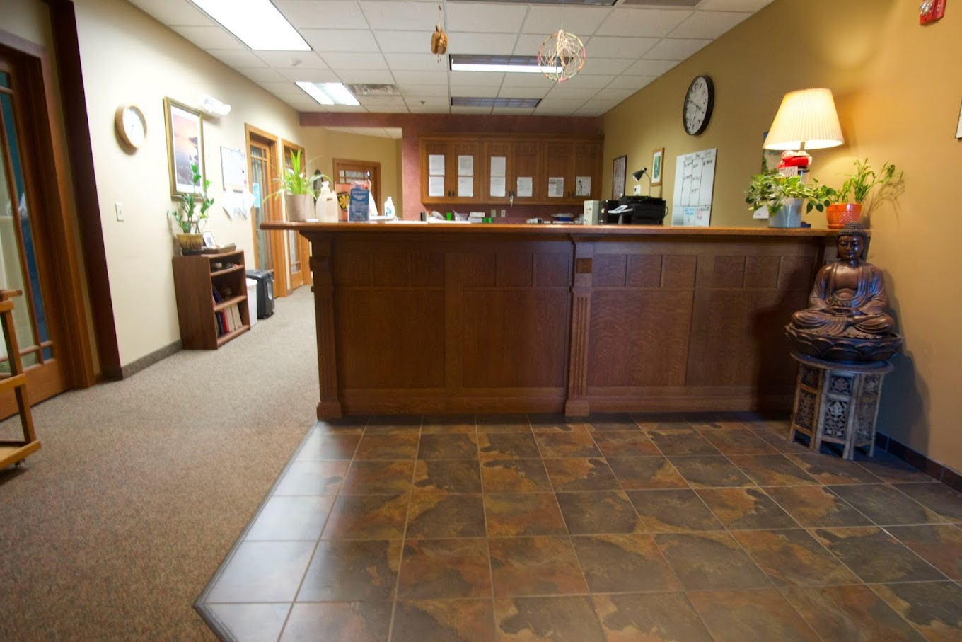 A warm-toned reception area with a wooden counter and décor