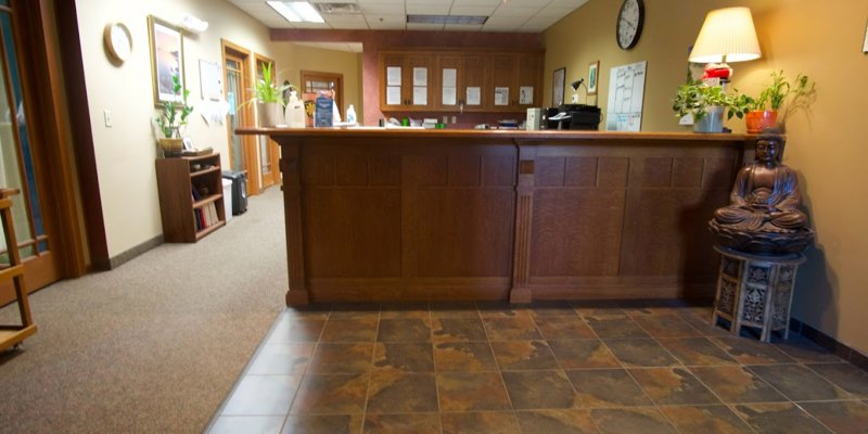  A warm, inviting reception area featuring wood accents, cozy lighting, and calming decor, creating a welcoming environment for visitors.