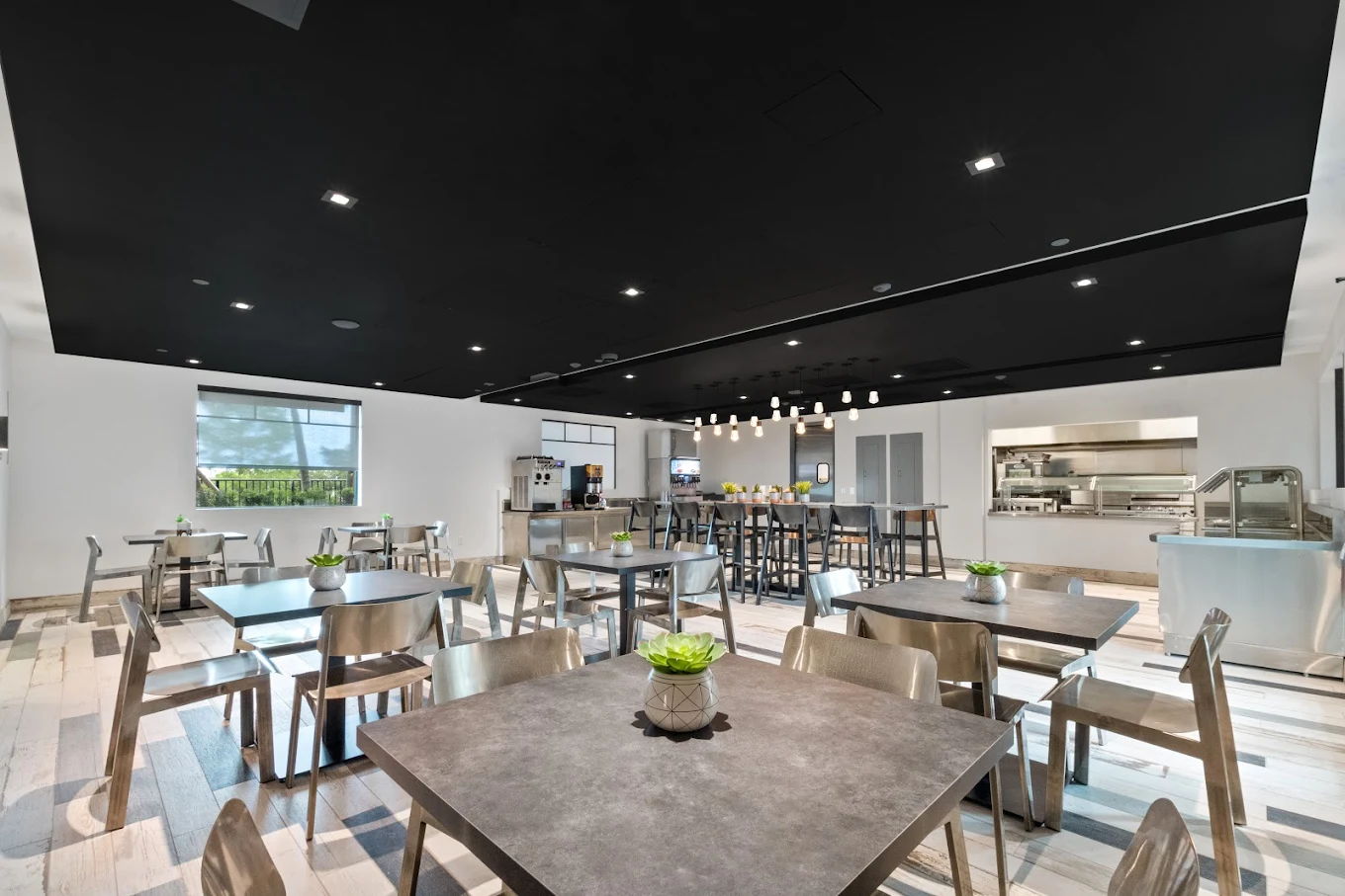 Spacious cafeteria with tables and serving area