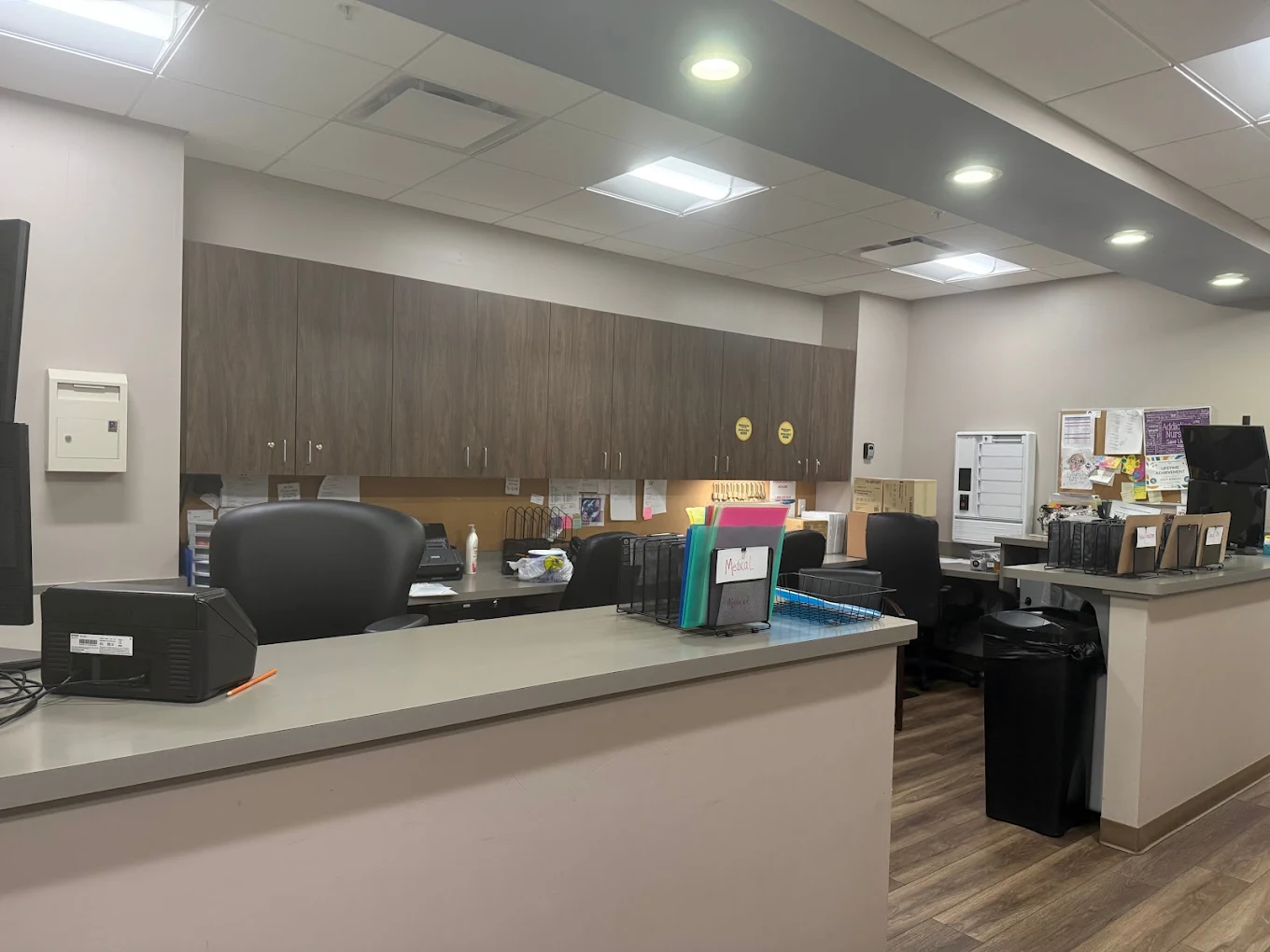 Staff workstation with counters, cabinets, and office supplies