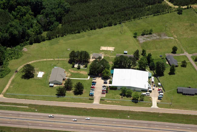 Aerial view of rehab campus with buildings and green fields
