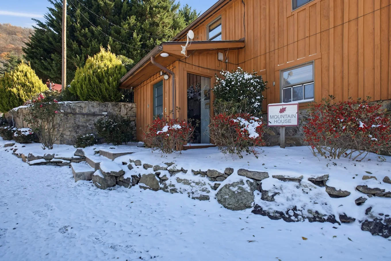 Mountain House exterior with snow and surrounding trees