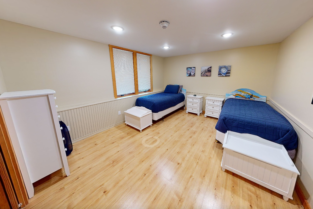 Shared bedroom with two single beds and personal storage