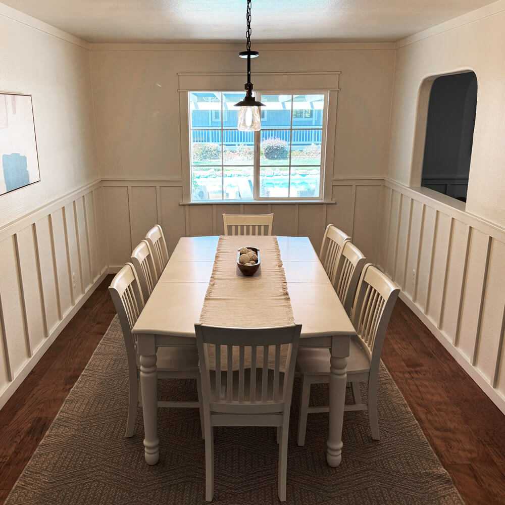 Bright dining area with white table and chairs