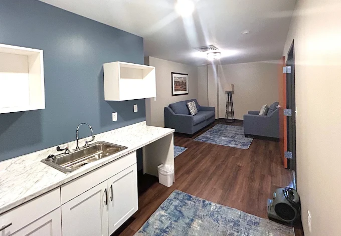 Client suite with kitchenette and sitting area