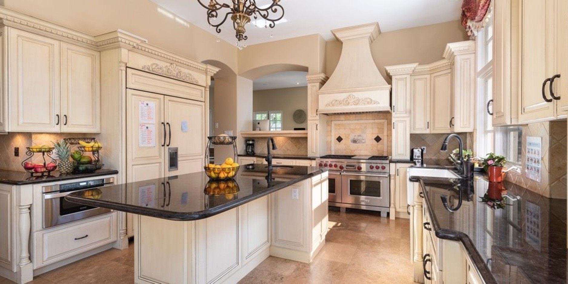 Bright kitchen with large island and cream cabinetry
