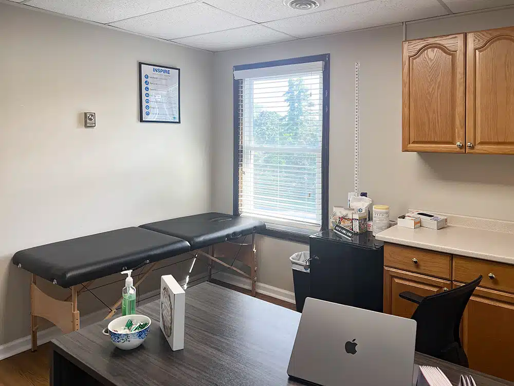 Exam room with treatment table and medical supplies