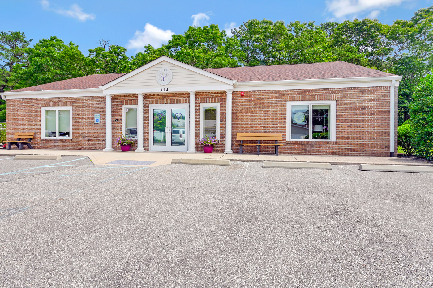 Brick facility entrance with columns and front walkway