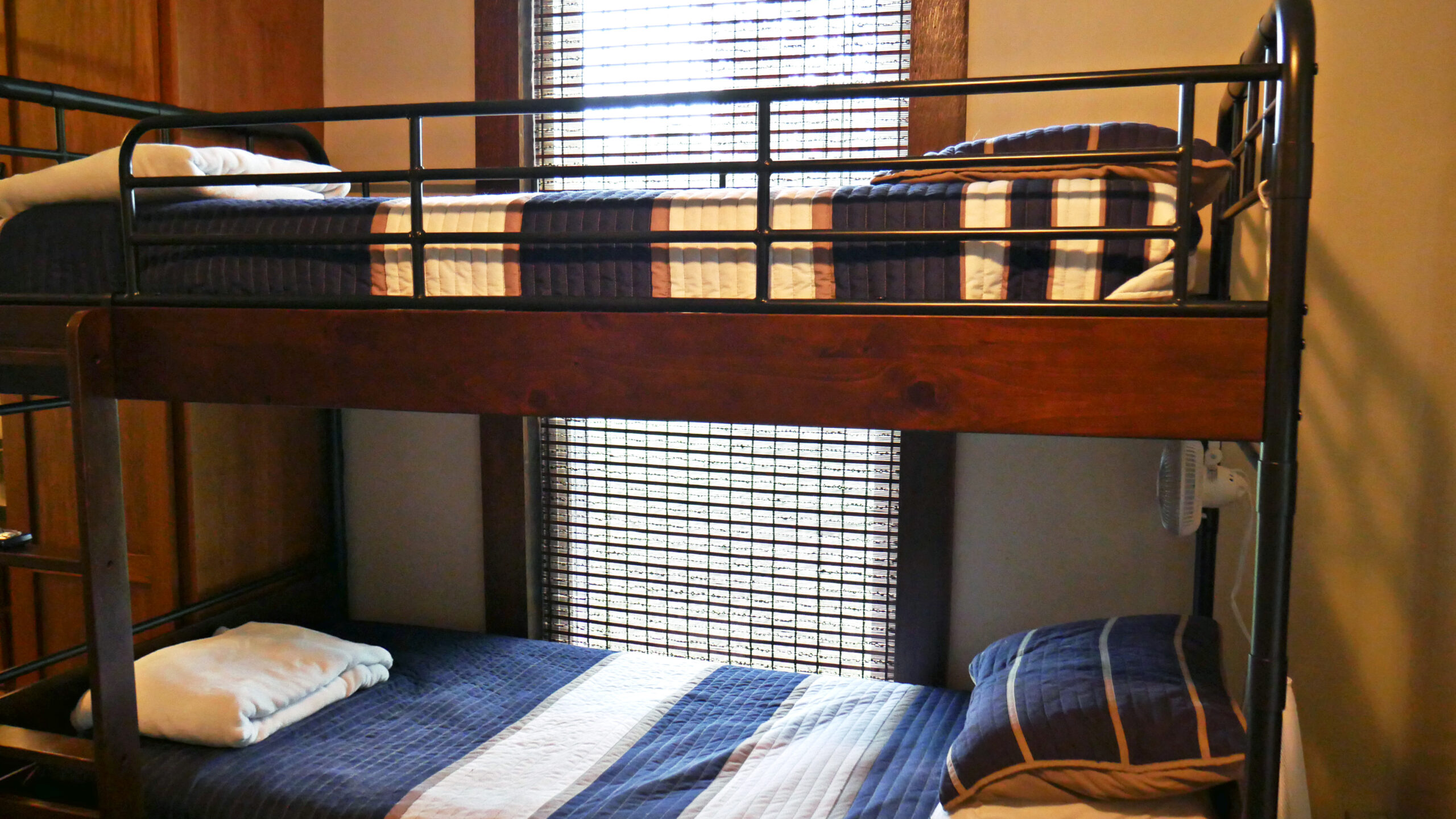 Shared bedroom with bunk beds and striped bedding