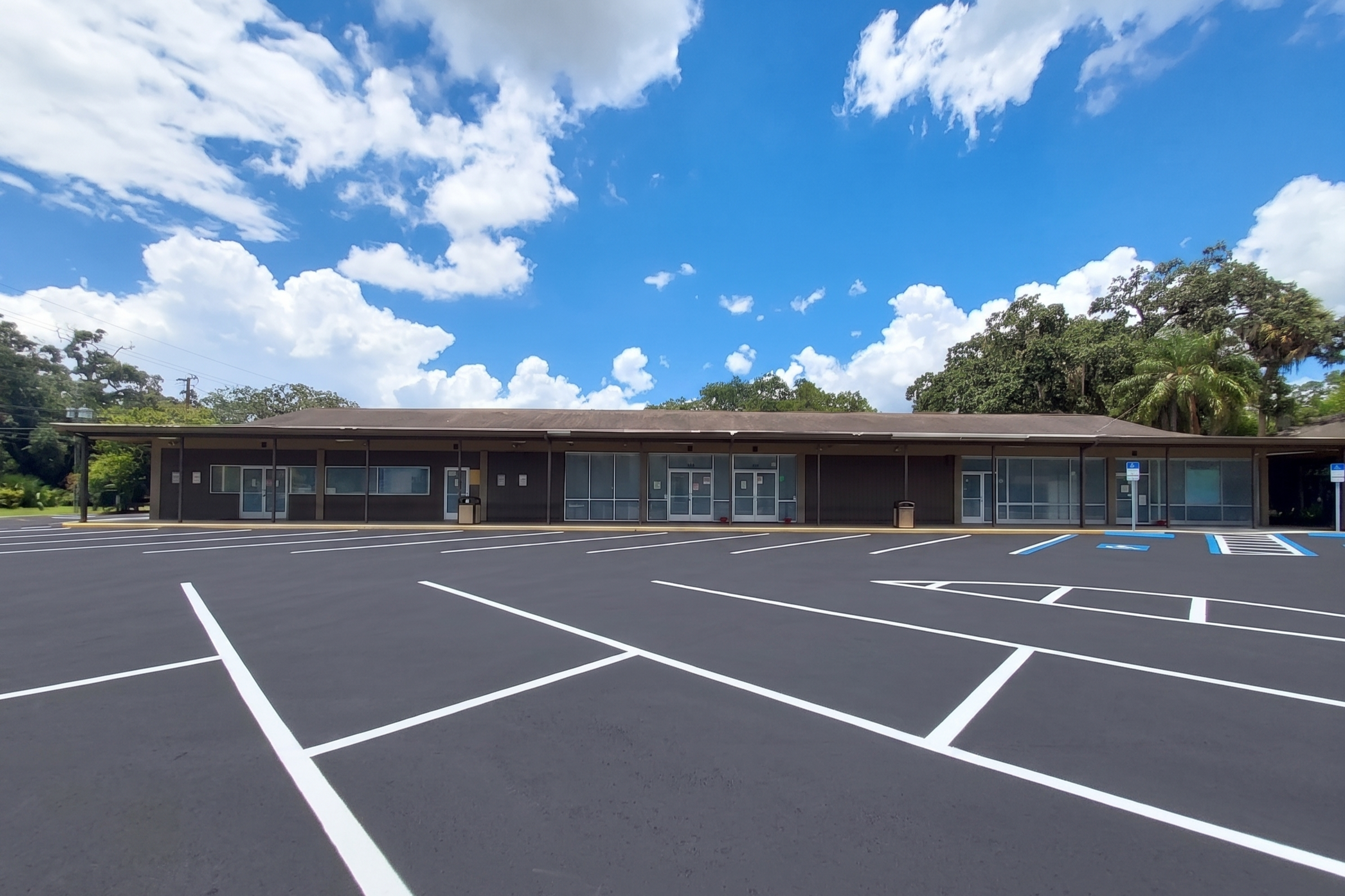 Rehab facility exterior with large parking lot and entrance