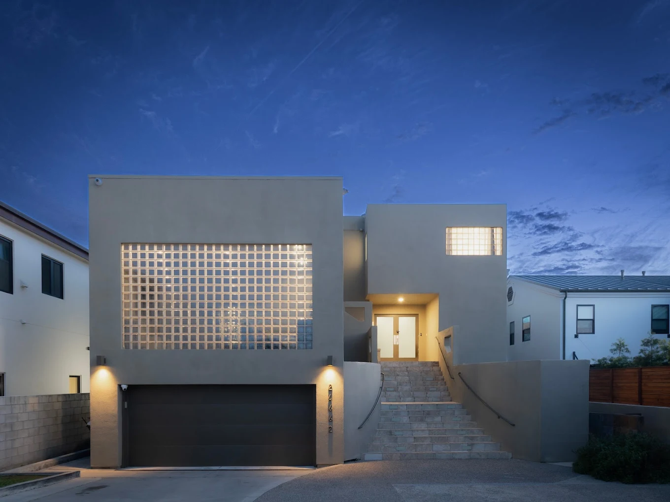 Modern beige building with steps and large glass block window