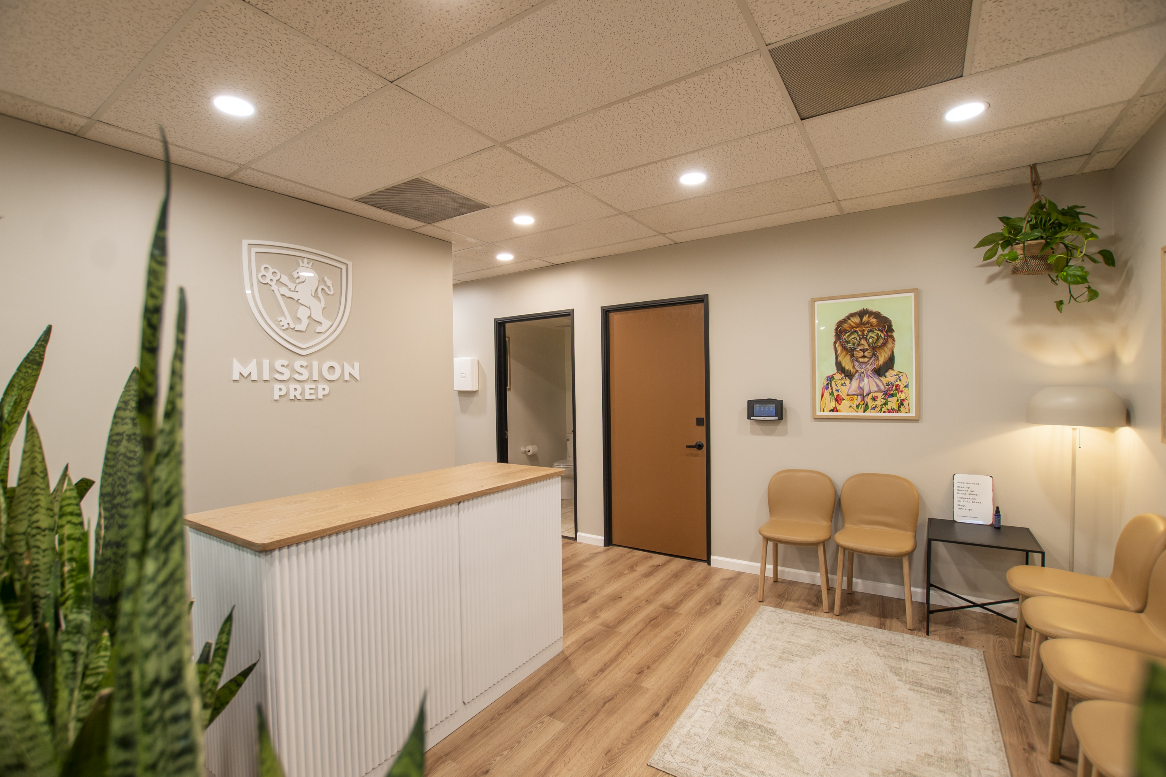 Front desk with Mission Prep logo and wood finish