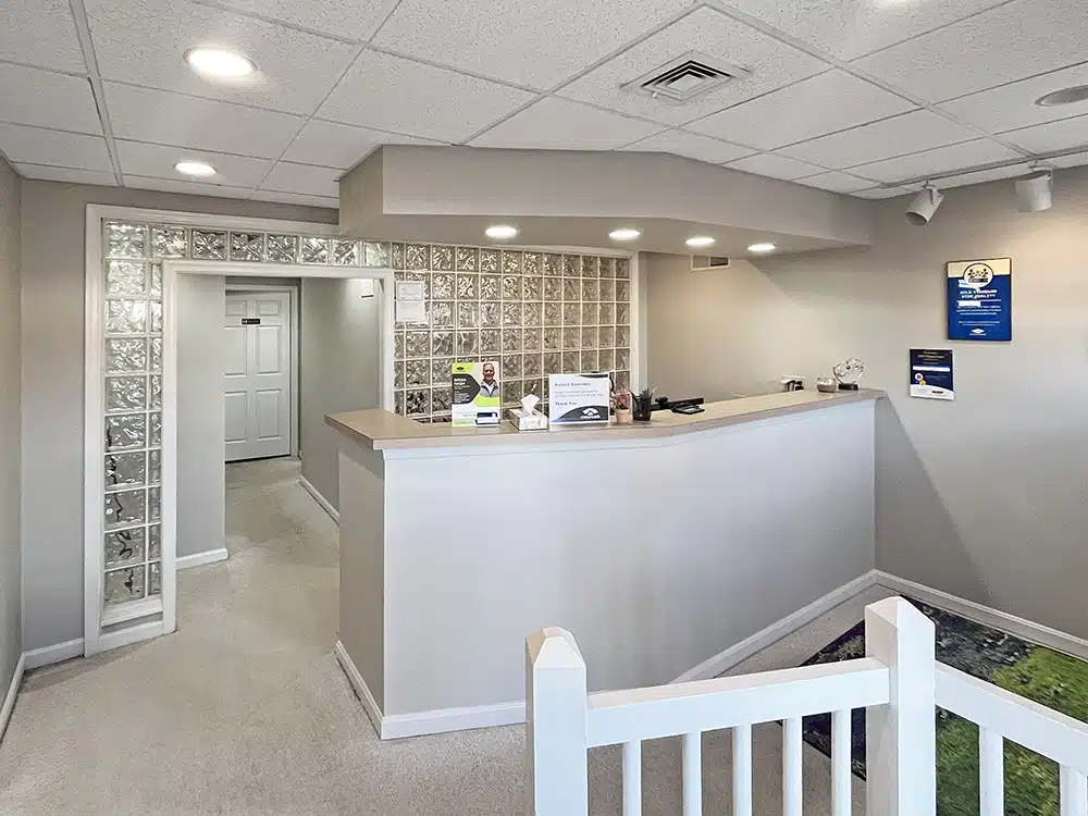 Reception desk with glass block wall and hallway