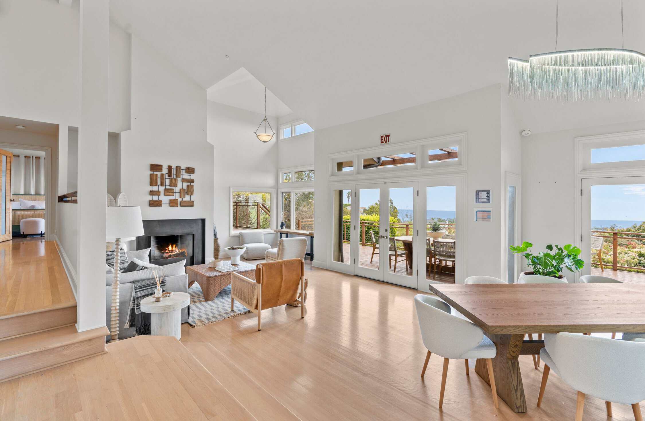 Open-concept lounge with fireplace and deck access