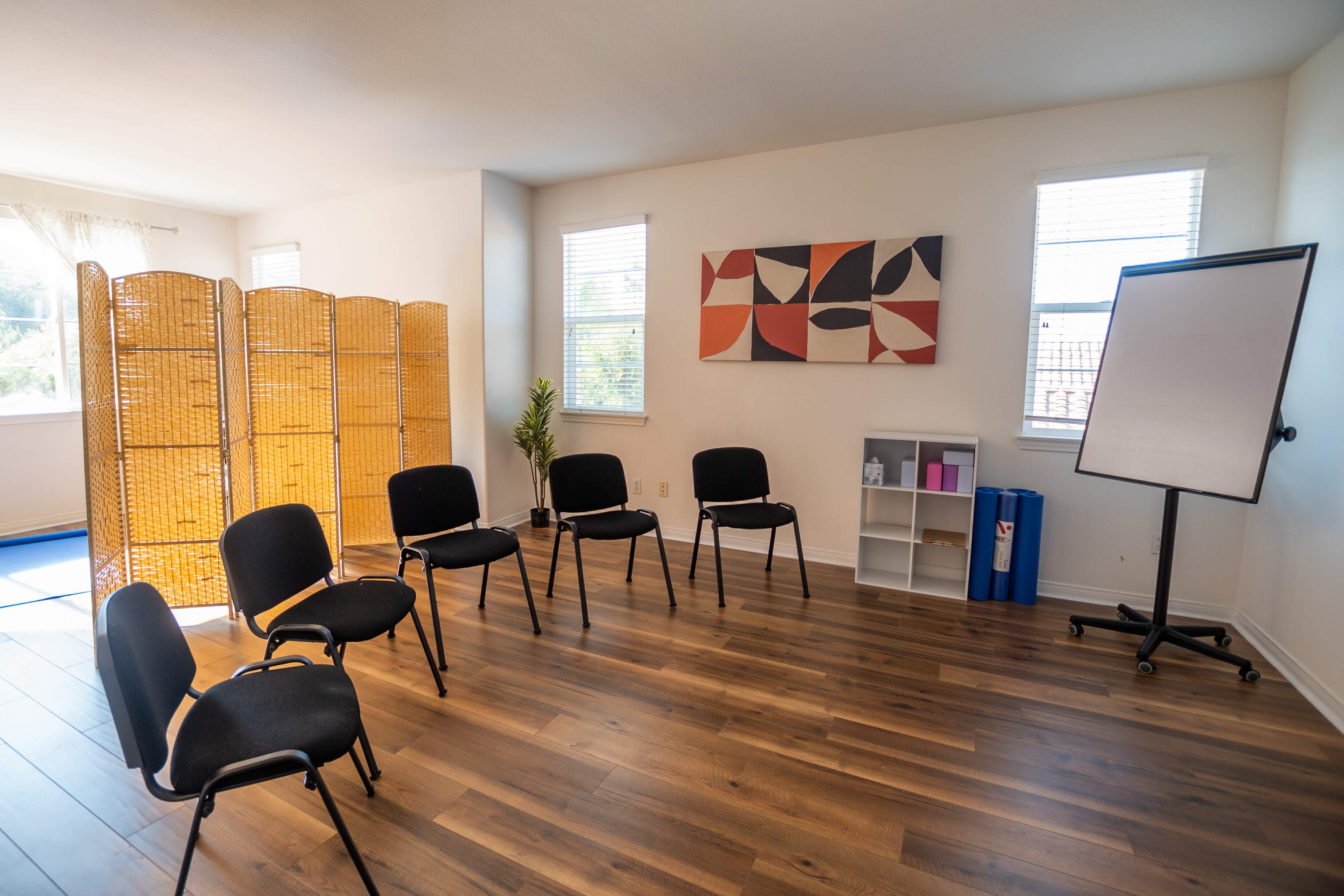 Room with circle of chairs and whiteboard for sessions